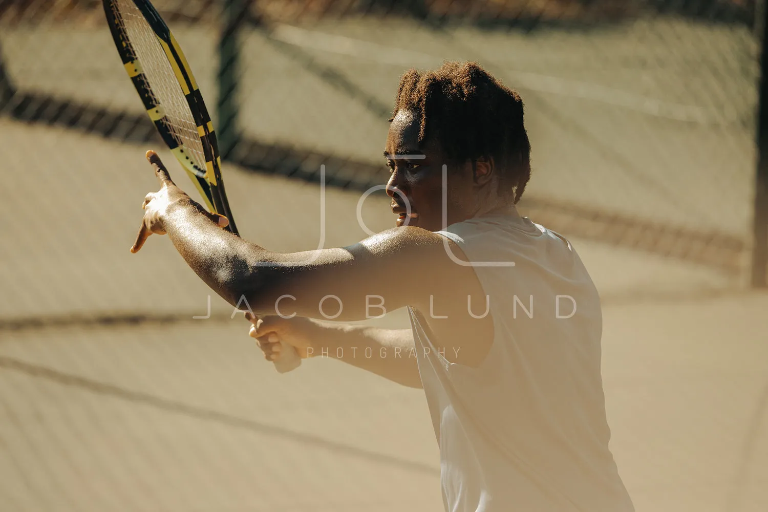 African-American man executing intense tennis forehand on hardcourt